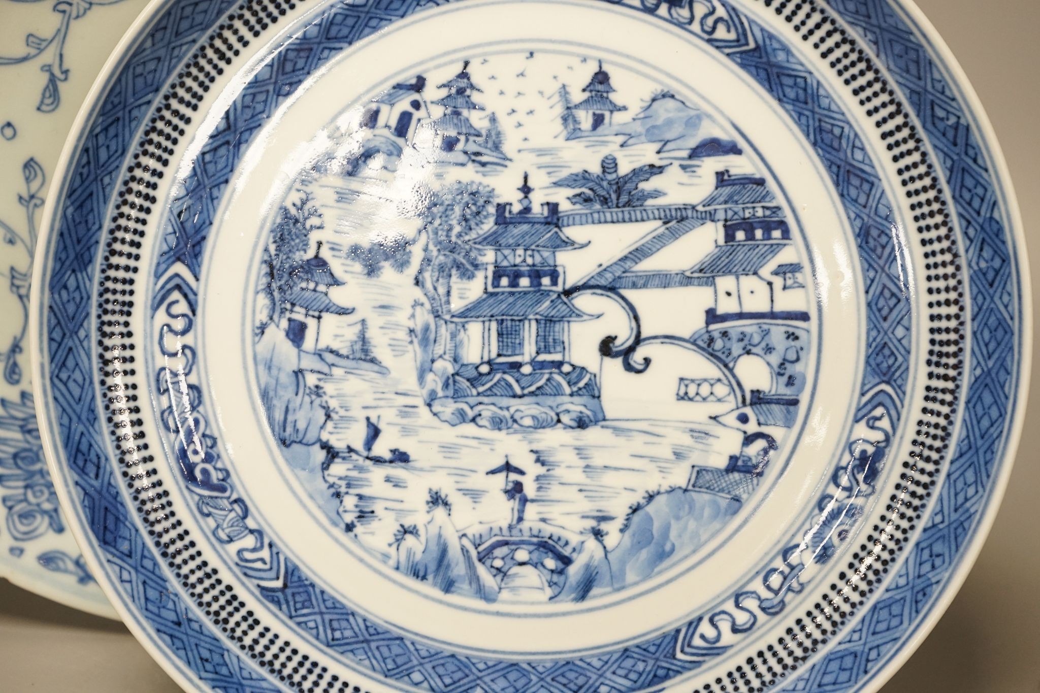 An 18th century Chinese blue and white bottle vase and two 19th century blue and white plates, diameter of largest plate - 25cm